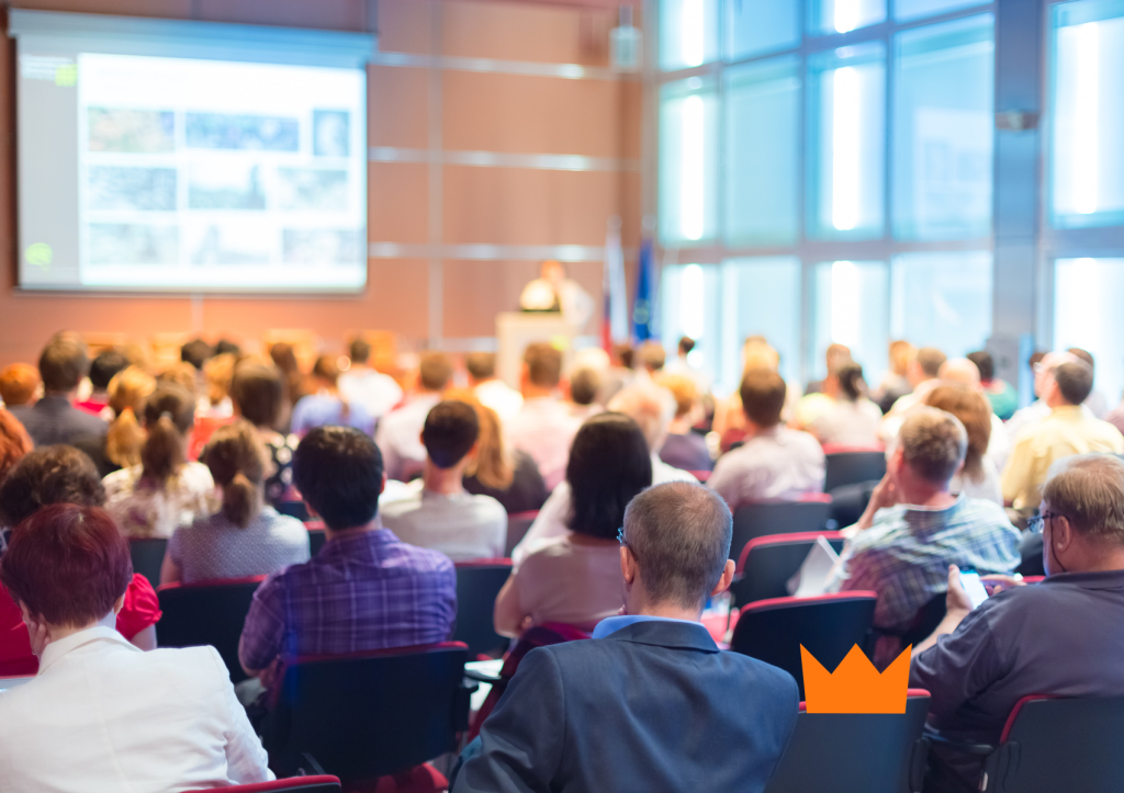 Imagem ilustrativa de evento corporativo com equipe interagindo em um ambiente profissional, representando tipos de eventos que funcionam para empresas, como conferências e networking.